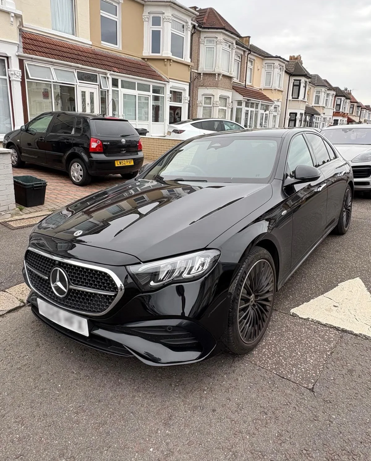 The same black Mercedes E-Class front bumper repaired, repainted and polished to a gloss finish